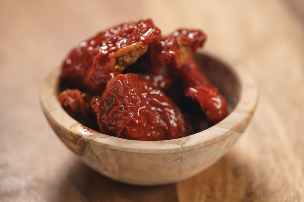 sundried tomatoes in wood bowl on table